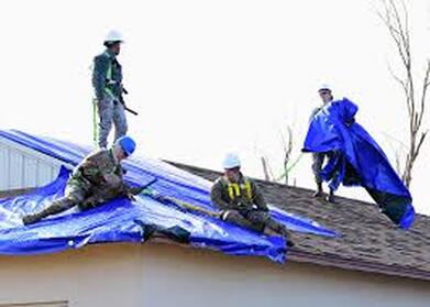 Picture of workers tarping roof